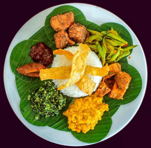 a plate of food with rice and vegetables on it at Insight Resort Ahangama - S&S Other Certified in Ahangama