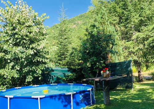 a picnic table in a yard with trees at Villa ORKA Pelister - Forest Zone in Bitola