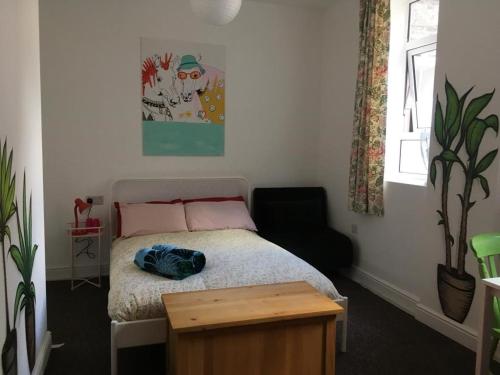 a small bedroom with a bed and a chair at Igloo Hybrid in Nottingham