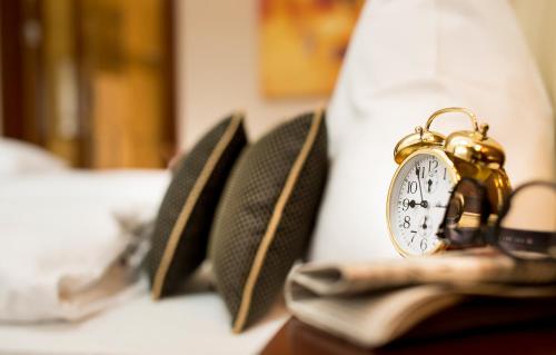 a gold alarm clock sitting on top of a book at Residence Bellevue in Boppard
