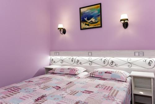 a bedroom with a bed and two pillows on it at Kirios Hotel in Nesebar