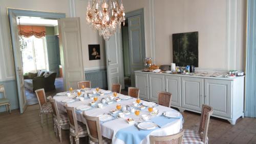 a dining room table with chairs and a table cloth at B&B De Corenbloem Luxury Guesthouse - Adults Only in Bruges
