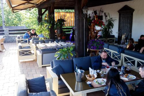 a group of people sitting at tables in a restaurant at ЕДБУРГ Готельно-ресторанний комплекс in Nizhnedneprovsk