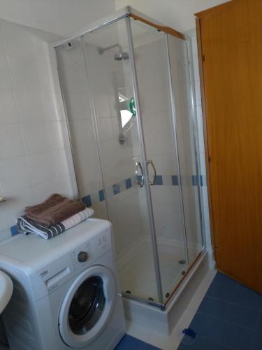 a bathroom with a washing machine and a shower at Via Brecce Bianche, 70 in Ancona
