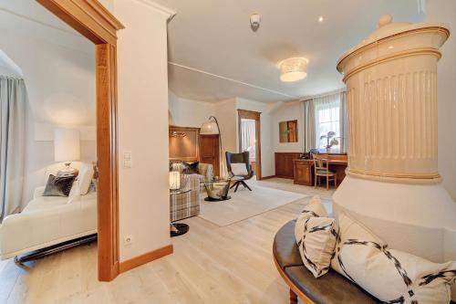 a living room with a bed and a dining room at Wellness- & Sporthotel Jagdhof in Röhrnbach