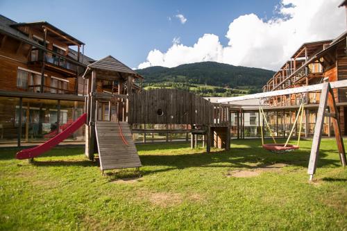 a playground with a slide and swings at Club Hotel am Kreischberg in Sankt Georgen ob Murau