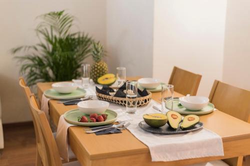 a dining room table with plates of food on it at Villa Di Mare Seaside Suites in Ixia