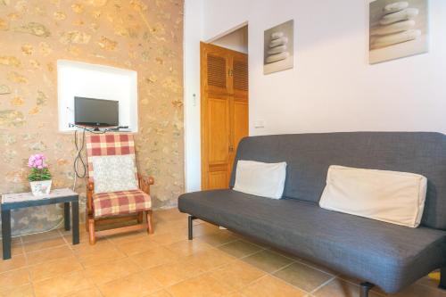 a living room with a couch and a chair at Can Fabiol - Adults Only in Sóller
