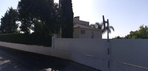a white fence in front of a white house at FIND Your Space Casa no Campo - Paderne - Albufeira - Piscina Privada - Aquecida a pedido in Paderne