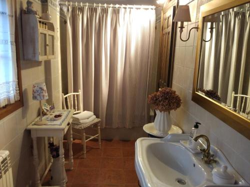 a bathroom with a sink and a mirror at El Collado in El Rasillo