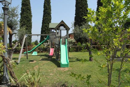 a playground with a slide in a garden at La Boheme Chambres in Lazise