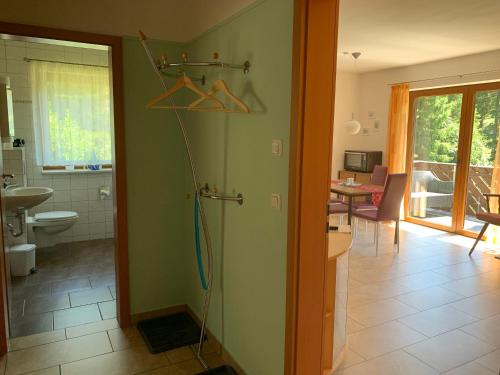 a bathroom with a shower with a hose hanging on the wall at Ferienwohnungen Börnert in Tellerhäuser