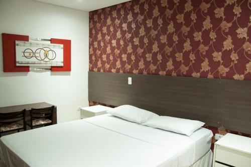 a bedroom with two beds and an american flag at Hotel Paddock in Sao Paulo