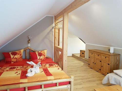 ein Schlafzimmer mit einem Bett mit einem ausgestopften Tier darauf in der Unterkunft Landpension Bielatal - Raum in Raum