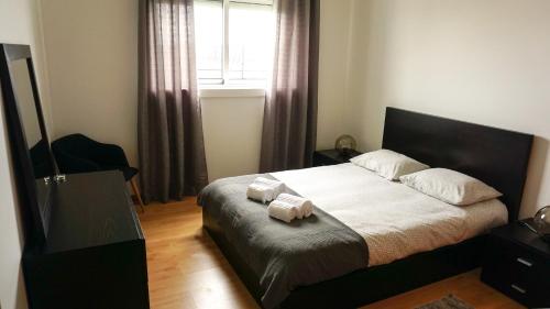 a bedroom with a bed with two towels on it at Vila Relvão in Vila Franca do Campo