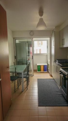a kitchen with a table and a dining room at Vila Relvão in Vila Franca do Campo