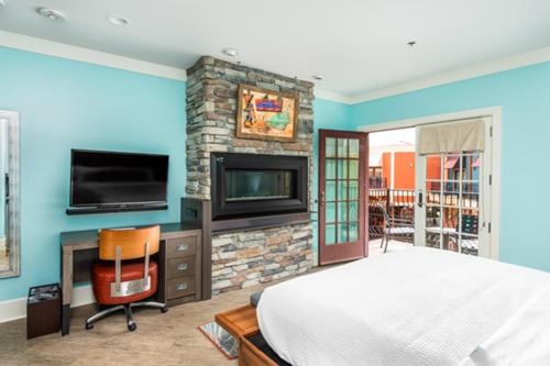 a bedroom with a bed and a fireplace and a tv at Margaritaville Island Hotel in Pigeon Forge