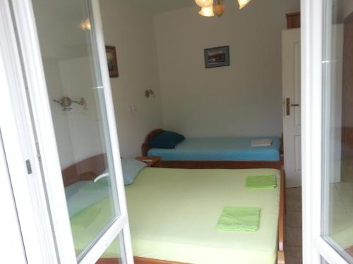 a small room with a mirror and a bed at Apartments Montenegro Risan Čučković in Risan
