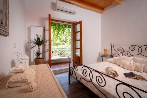 a bedroom with a bed and a table and a window at Villa BENEDETA-Dubovica Hvar in Hvar