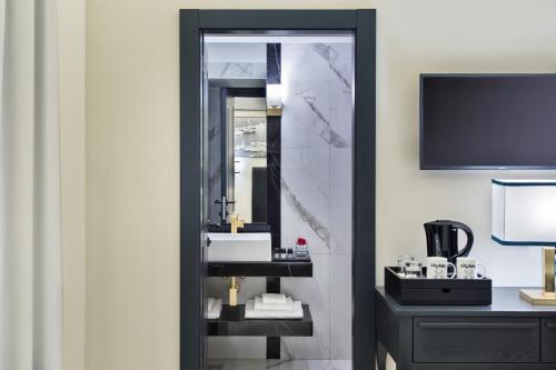 a bathroom with a sink and a mirror at Citykey Napoli - Bed & Breakfast in Naples