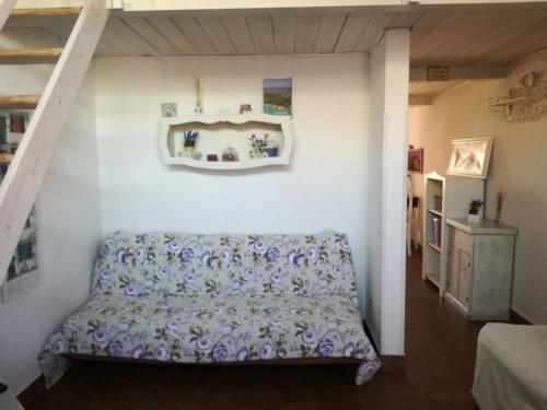 a bedroom with a bed and a white wall at Rome and the Beach Chianti in Ladispoli