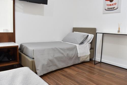 a bedroom with two beds and a wooden floor at b&b Donna Raffaela in Crotone