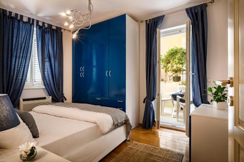 a bedroom with a blue accent wall and a bed at Valamar Riviera Hotel & Residence in Poreč