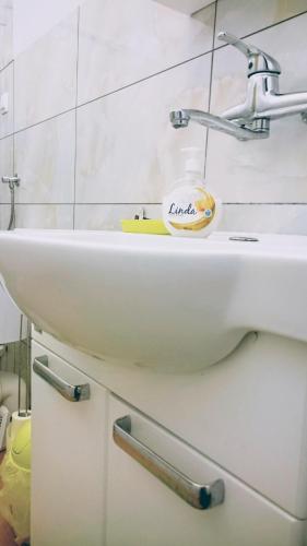 a bathroom with a sink with a cup on it at Kwatery w Gołdapi in Gołdap