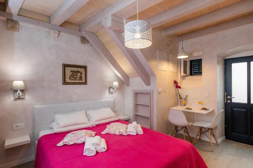 - une chambre avec un lit rouge et des serviettes dans l'établissement Old town Marko, à Dubrovnik