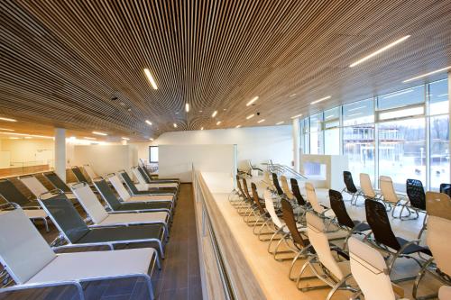 a large room with chairs and tables and windows at Vitalhotel der Parktherme - inkl Thermeneintritt & Sauna in Bad Radkersburg