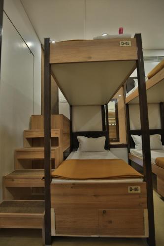 a bunk bed in a room with a staircase at Suvidha Ghar AC DORMITORY in Surat