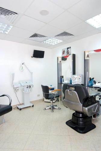 a hair salon with chairs and a mirror at Falcon Hills Hotel in Sharm El Sheikh