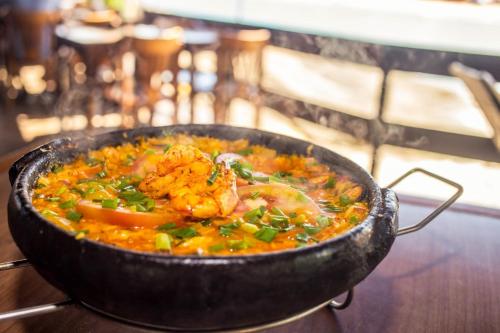 a bowl of food sitting on top of a table at Pousada Recanto da Pedra in Iriri