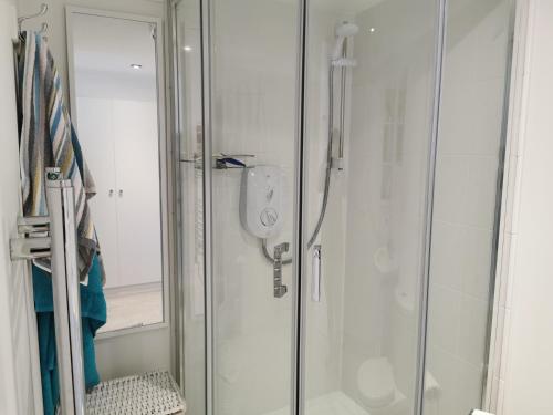 a shower with a glass door in a bathroom at Executive Annex - Dunfermline in Dunfermline