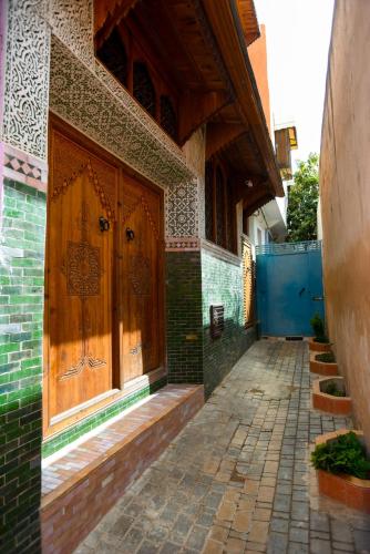 an entrance to a building with a large wooden door at Riad Mehdi Meknès in Meknès