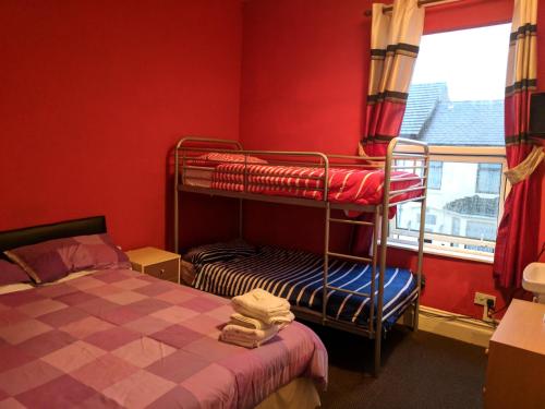 a bedroom with two bunk beds and a window at MyRoomz New Discovery Hotel in Blackpool