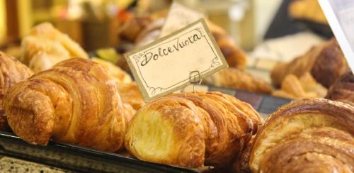 a bunch of pastries on display in a bakery at Casa Alessandrini in Bologna