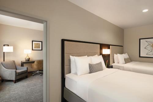 a hotel room with a bed and a chair at Radisson Hotel Oklahoma City Airport in Oklahoma City