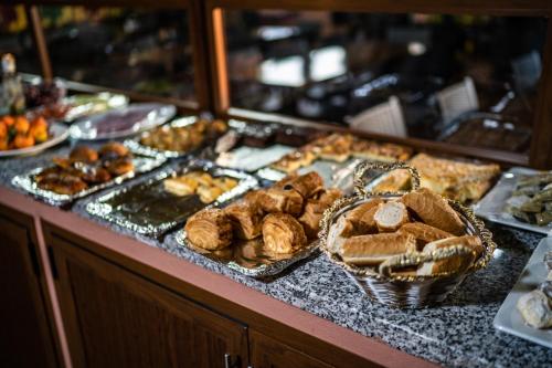 a buffet filled with different types of bread and pastries at Moroccan House in Marrakech
