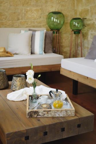 a coffee table with a tray of food on it at Serenity Boutique House in Vouni