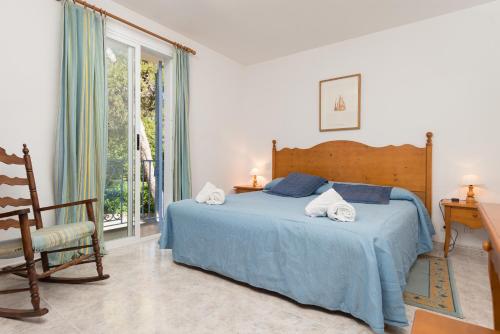- une chambre avec un lit, une chaise et une fenêtre dans l'établissement Clivies 1B, à Port de Pollença