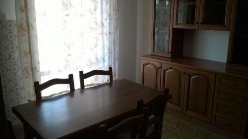 a dining room table with two chairs and a window at Appartamento grazioso e confortevole a Orbetello (GR) in Orbetello