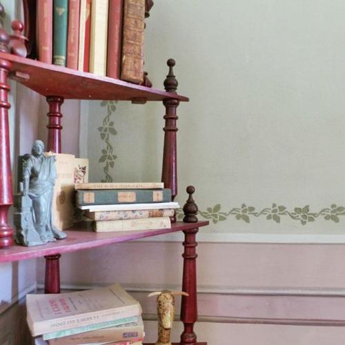 a book shelf with books on it with a pile of books at Casa Borio in Bioglio