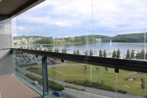 a large window in a building with a view of a lake at Menuetti - best lake view in Jyväskylä