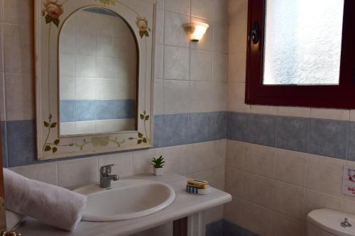 a bathroom with a sink and a mirror at Anais Apartments in Chios