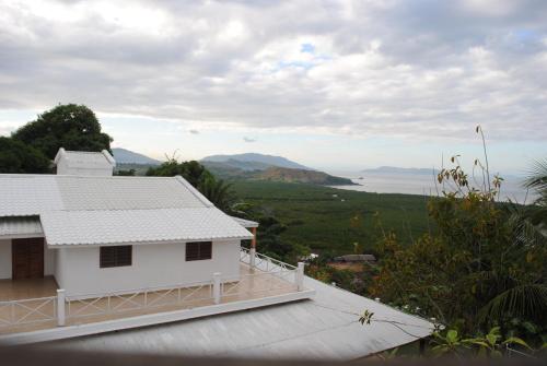 a white house with a view of the ocean at Villa Palissandre in Nosy Be