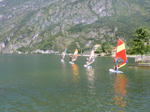 a group of people on sailboards in the water at Caffè del Viaggiatore in Valsolda