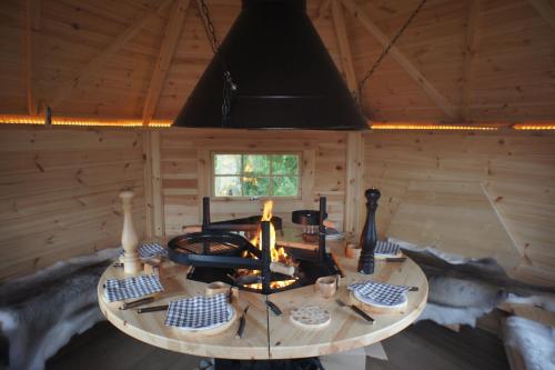 une chambre avec une table dans une cabane en rondins dans l'établissement Aux Logis de la Solre, à Ferrière-la-Petite