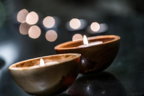 two small candles sitting on a table with lights at Salles Hotels Marina Portals in Portals Nous