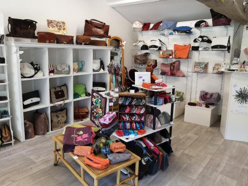 a store filled with lots of bags and shoes at Les Mesanges in Combrand
